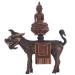 A Southeast Asian polychrome and gilt painted wooden qilin, carrying a seated Buddha on its back, H