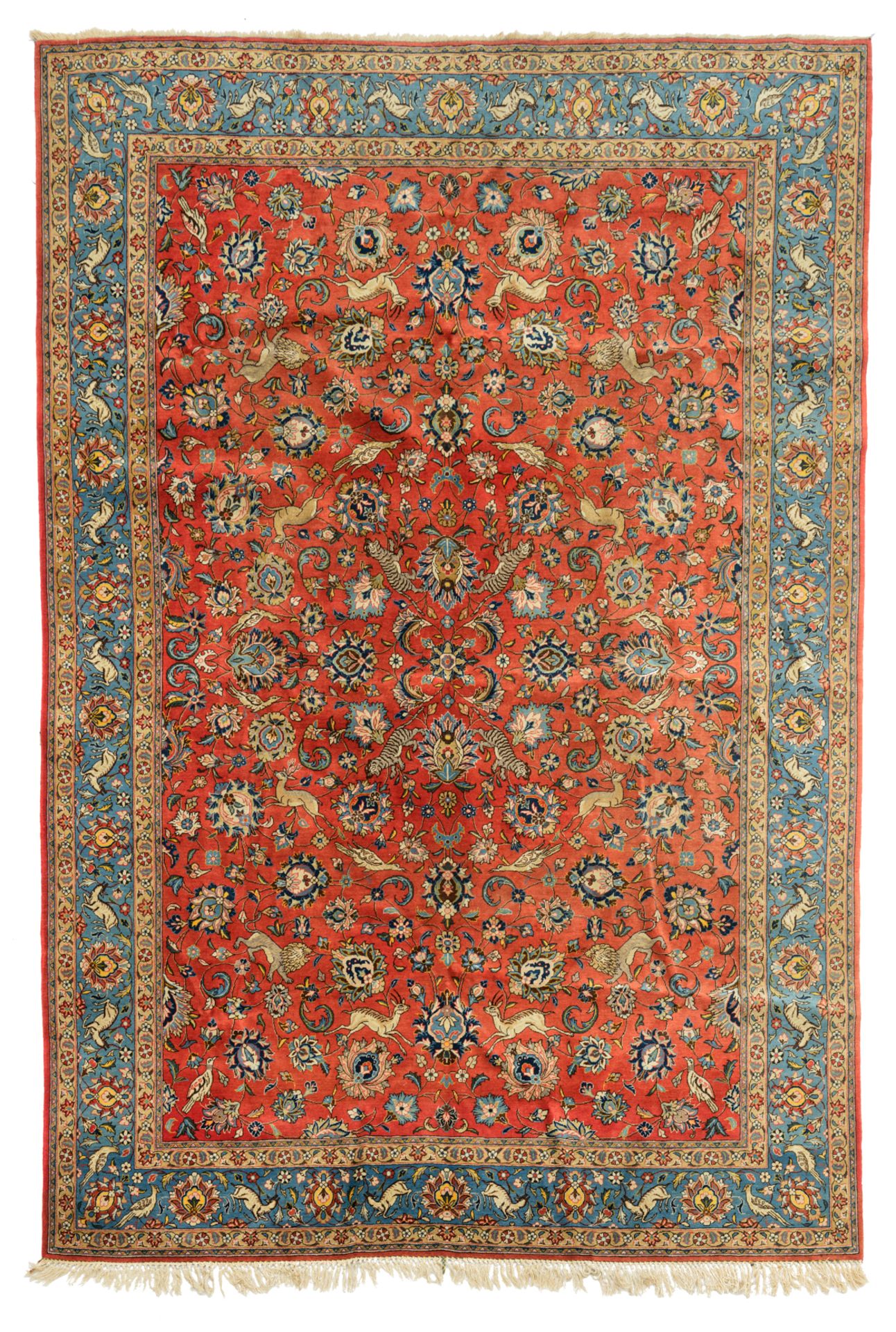 An Oriental woollen rug, decorated with hunting lions, deer and birds surrounded by flowers, 234 x 3