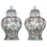 A pair of Chinese famille verte covered vases, decorated with phoenix and blossoming prunus branches