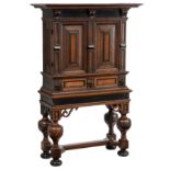 A Baroque oak and ebony veneered cabinet-on-stand or a so-called 'Luiermandskast' (layette cupboard)