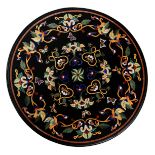 A round tabletop in Italian pietra dura, decorated with geometric motifs in various types of marble,