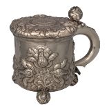 A German silver plated tankard, the body, lid and ball-feet relief decorated with fruits and flowers