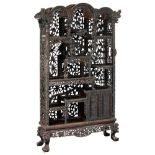 A Chinese exotic hardwood display cabinet, finely sculpted with floral decorations, dragons and Fu l