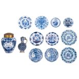 A collection of ten 18thC blue and white decorated Dutch Delftware dishes, decorated with garden sce