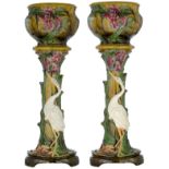 A pair of French Art Nouveau polychrome painted and relief decorated cachepots on stand, decorated i