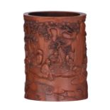 A Chinese bamboo brush pot, carved with scholars in an outdoor setting with pine trees and bamboo, s