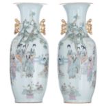 A pair of Chinese polychrome vases, decorated with an animated scene with a musician, the reverse wi