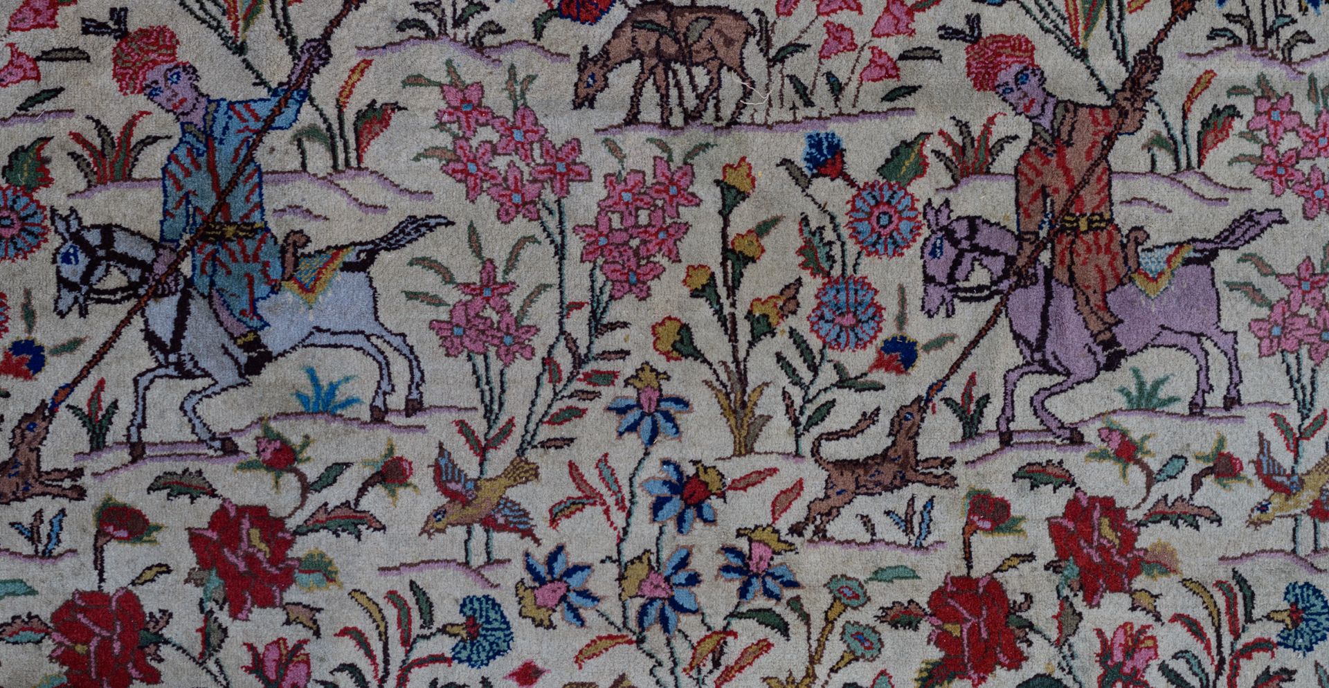 An Oriental woollen rug, decorated with hunting scènes to the center, and with animals and floral mo - Image 6 of 9