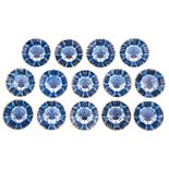 A collection of fourteen blue and white 'peacock tail' decorated Dutch Delftware dishes, eight of th