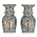 A pair of Chinese Canton famille rose on celadon ground vases