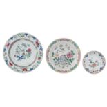 Two Chinese floral decorated famille rose chargers; added a ditto dish