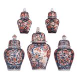 A collection of five Japanese Imari vases and covers