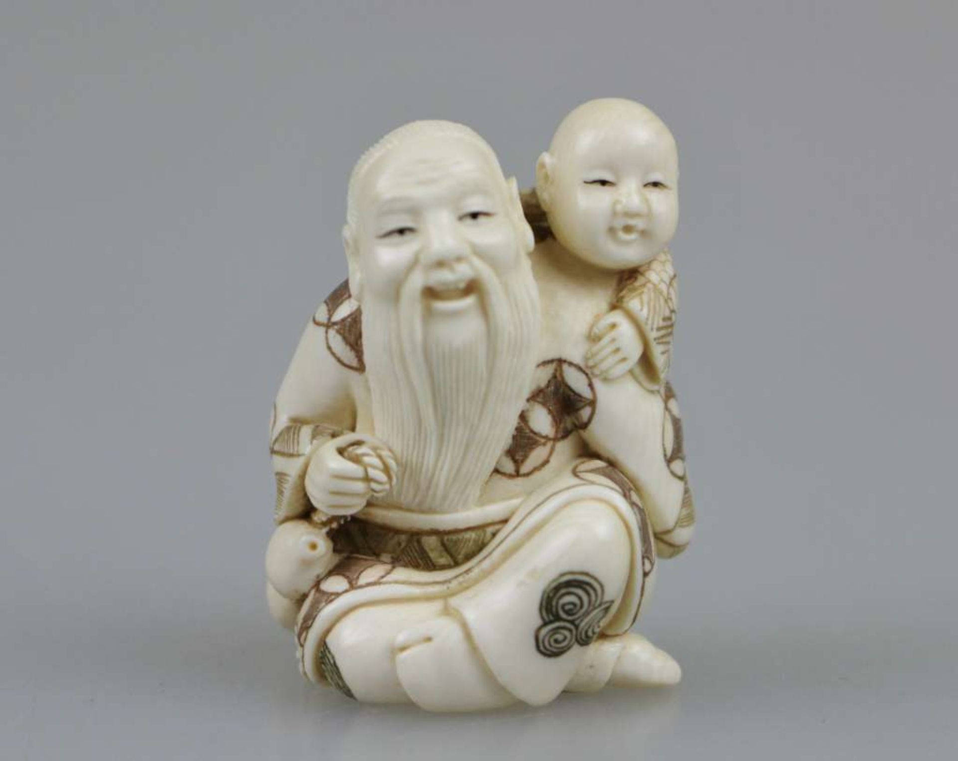 Netsuke, Japan, wohl 19. Jh., sitzender, alter Mann mit Kind auf der Schulter, Elfenbein, am Boden - Bild 2 aus 4