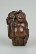 Okimono, Japan, wohl 19. Jh., Hotei mit Mann auf der Schulter, Holz, am Boden Signatur, H.: ca. 6,