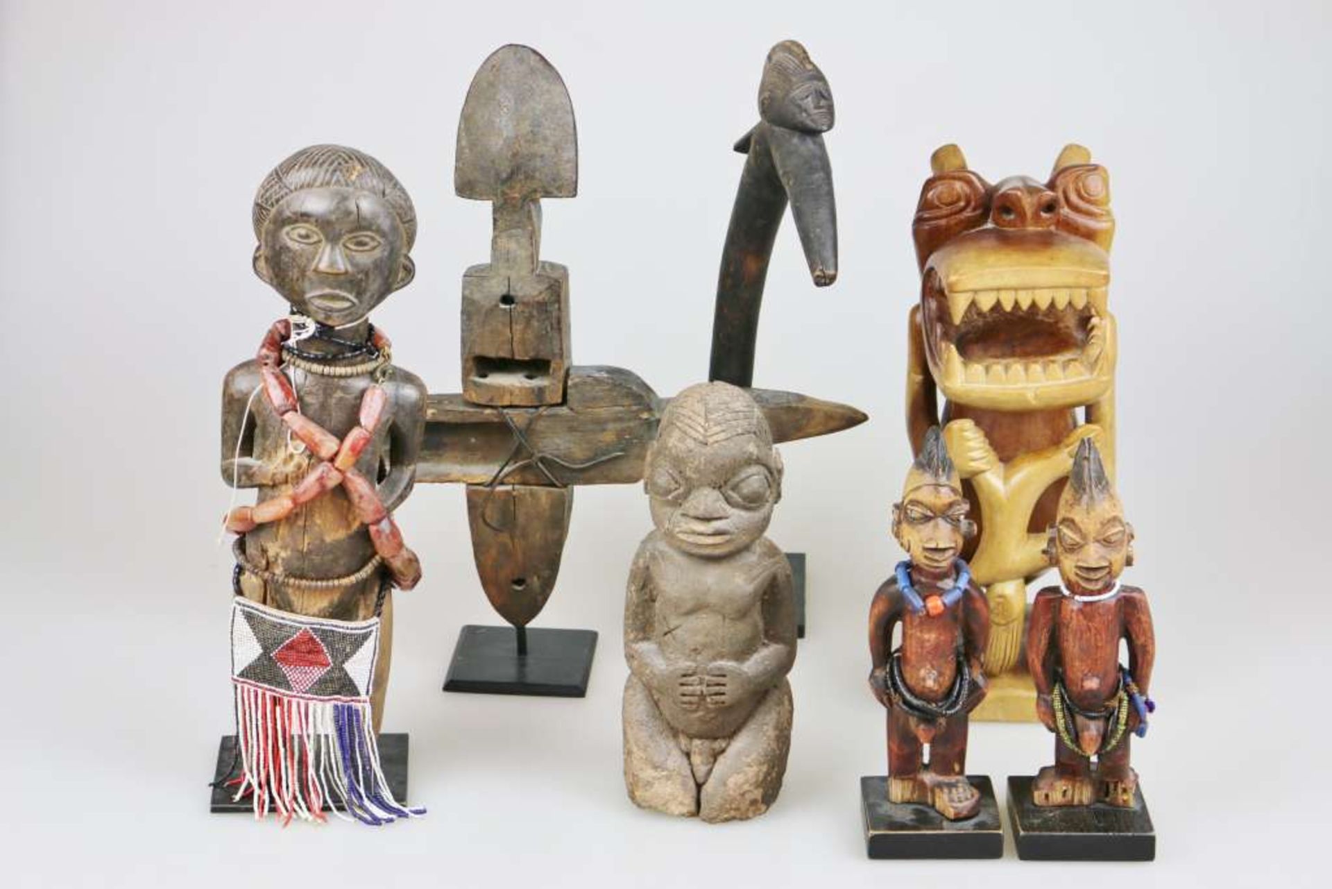 Konvolut afrikanischer Figuren, 7-teilig, Holz u. Stein, partiell mit Perlengehänge und Schmuc