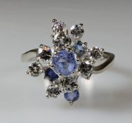 Ring, WG 750, 4 runde facettierte nahezu farblose Saphire, 9 Brillanten zus. ca. 1.05 ct., etwa fw-