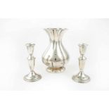 A pair of candlesticks and a vase