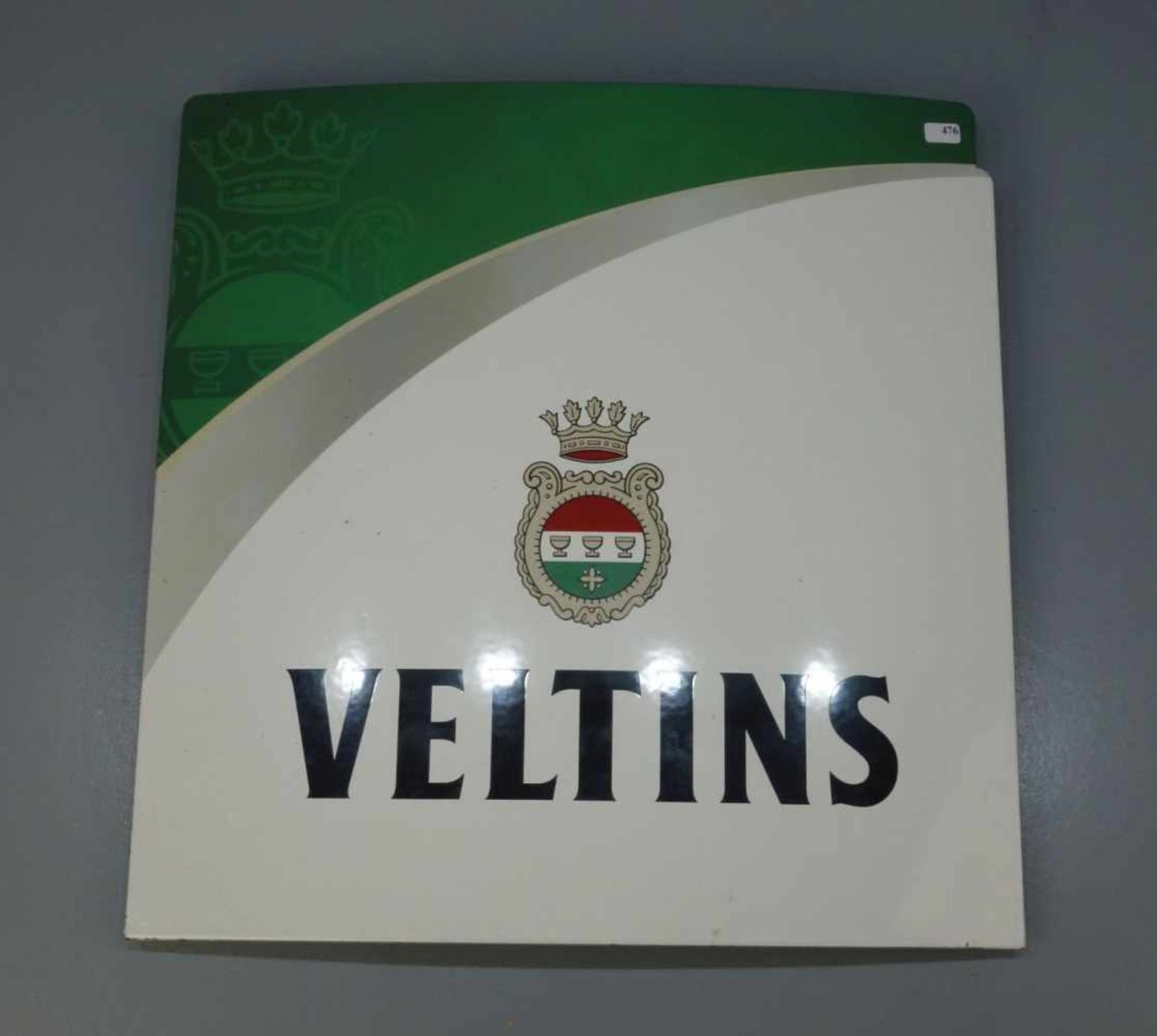 EMAILLESCHILD / BLECHSCHILD / WERBESCHILD "Veltins". Annähernd quadratisches, leicht aufgewölbtes