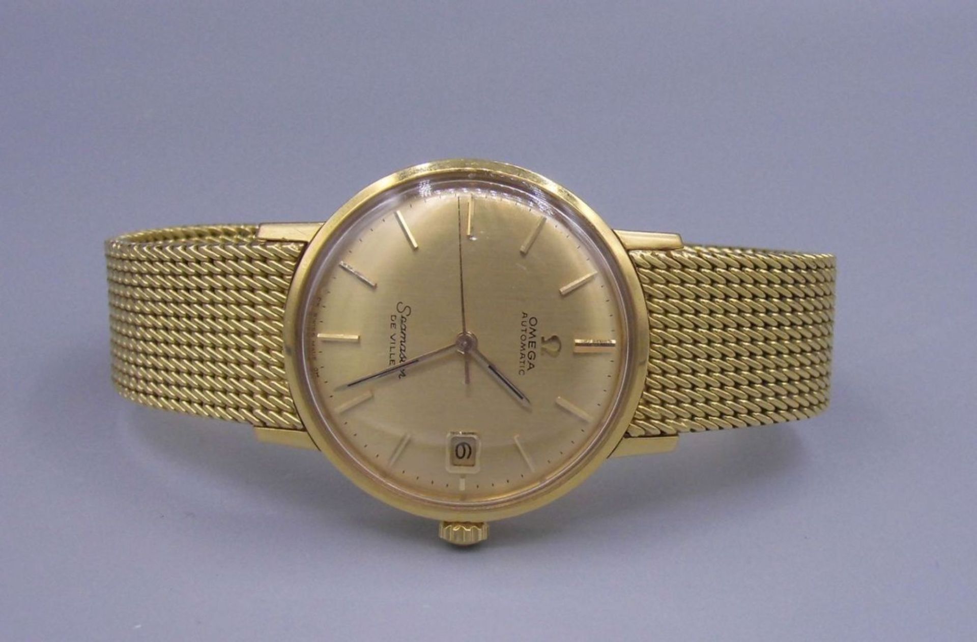 GOLDENE ARMBANDUHR / wristwatch, Automatik-Uhr, Manufaktur Omega, Modell "Seamaster De Ville".