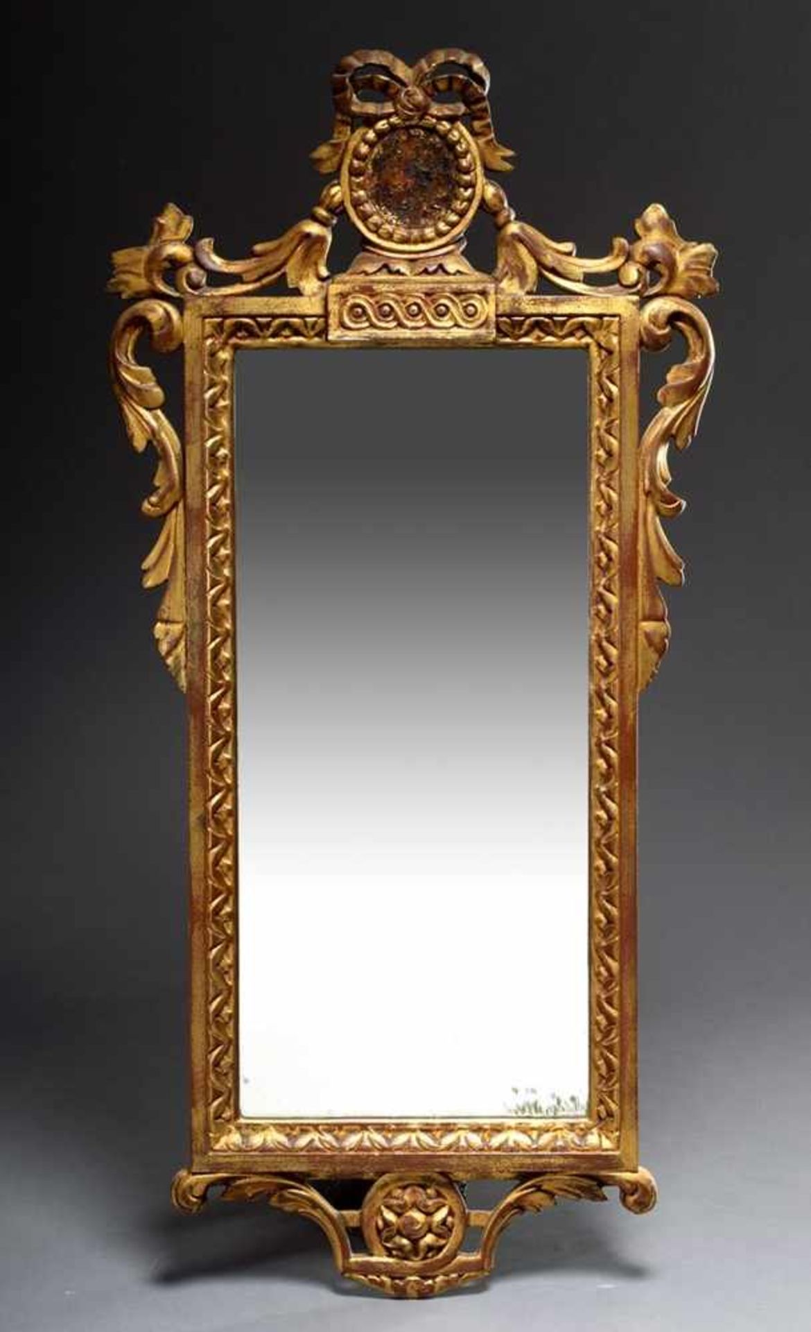 Small console mirror in classicistic style with medallion crown and draperies, wood carved and