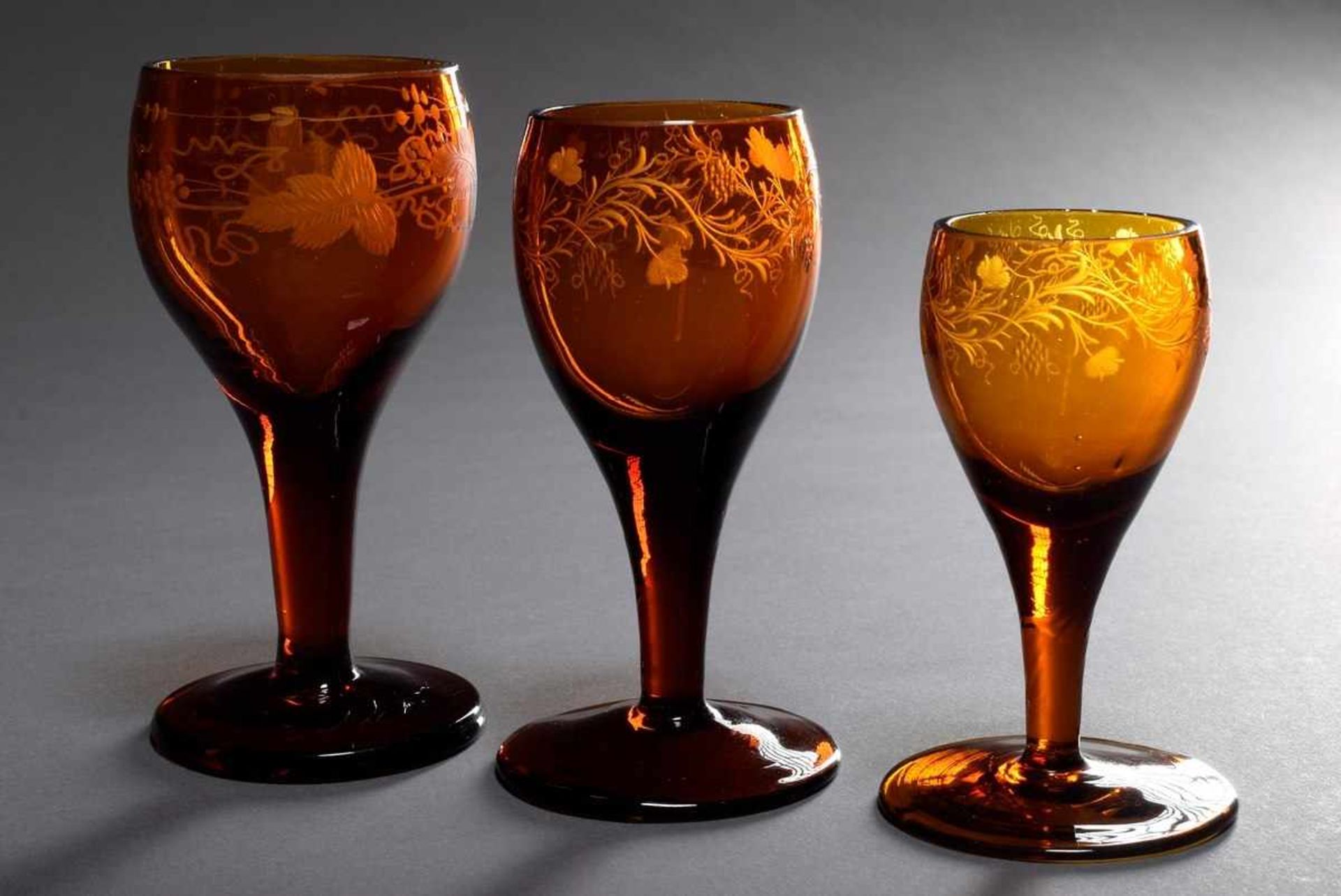 3 Various glasses of amber glass with cut vine tendrils, 19th century, h. 10-13cm, edges slightly