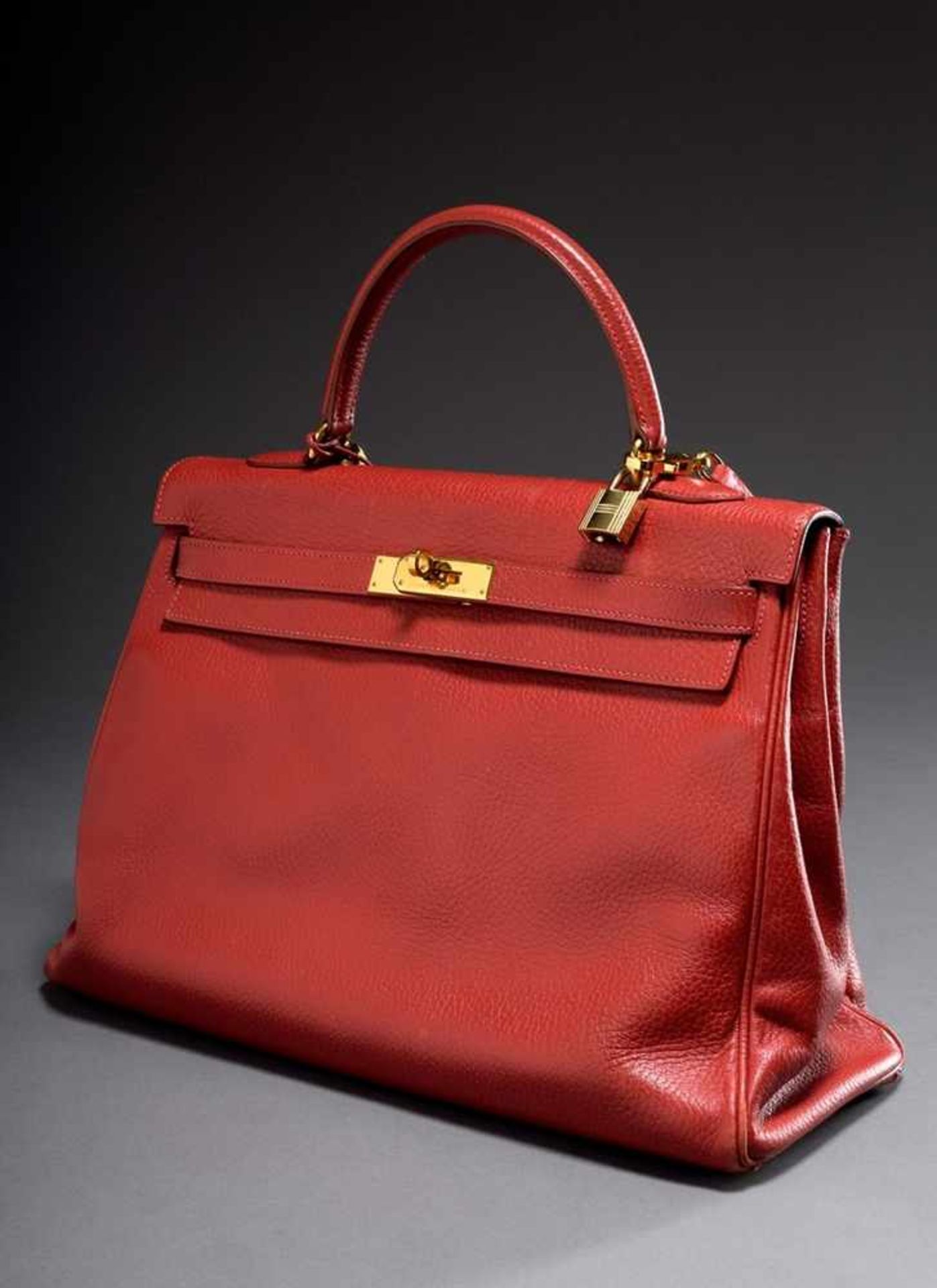 Hermès "Kelly Bag Souple 35", 1998, red calfskin, trapezoid body with arched handle, flap with