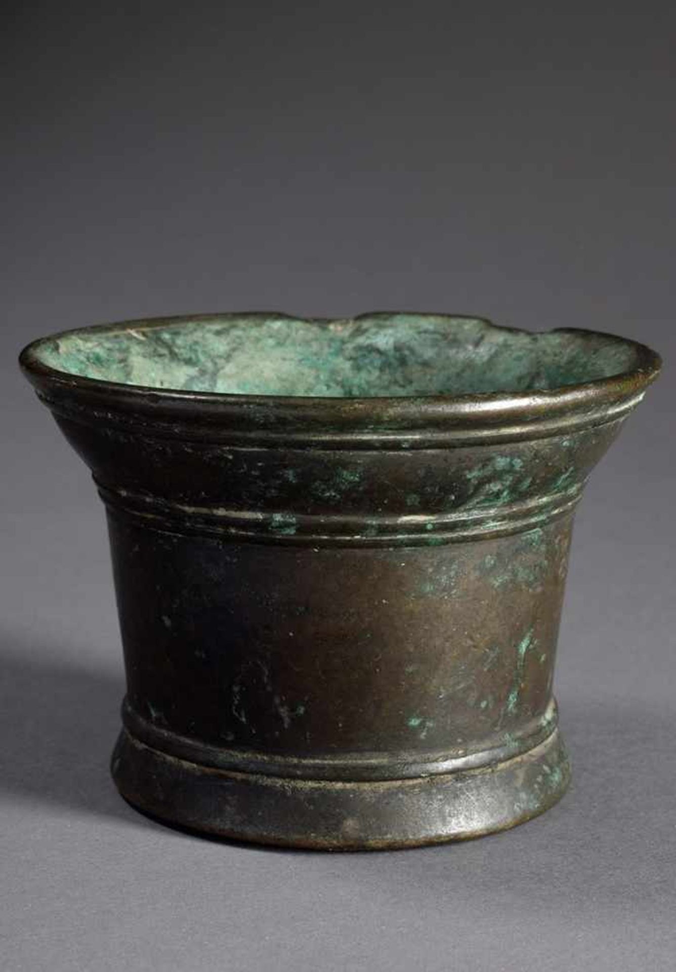 Small bronze mortar with projecting rim and longitudinal grooves, dark patina, probably German