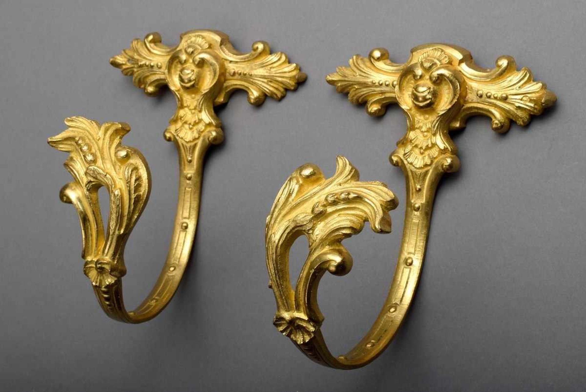 Pair of gilded bronze curtain holders with floral relief, backside inscribed EG 329, 19th century,