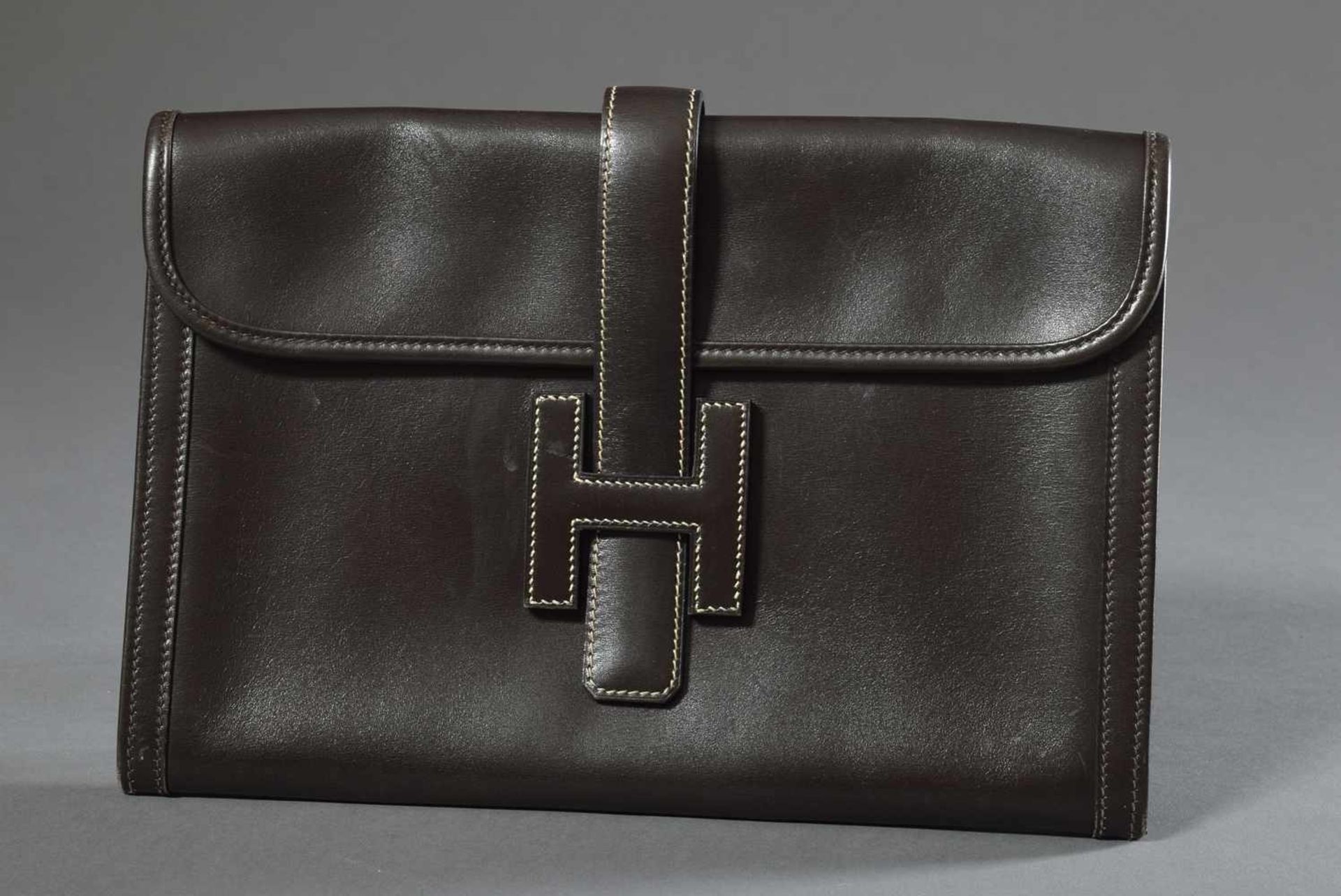 Hermès Clutch with big leather "H" buckle, dark brown boxcalf leather, inside light linen,