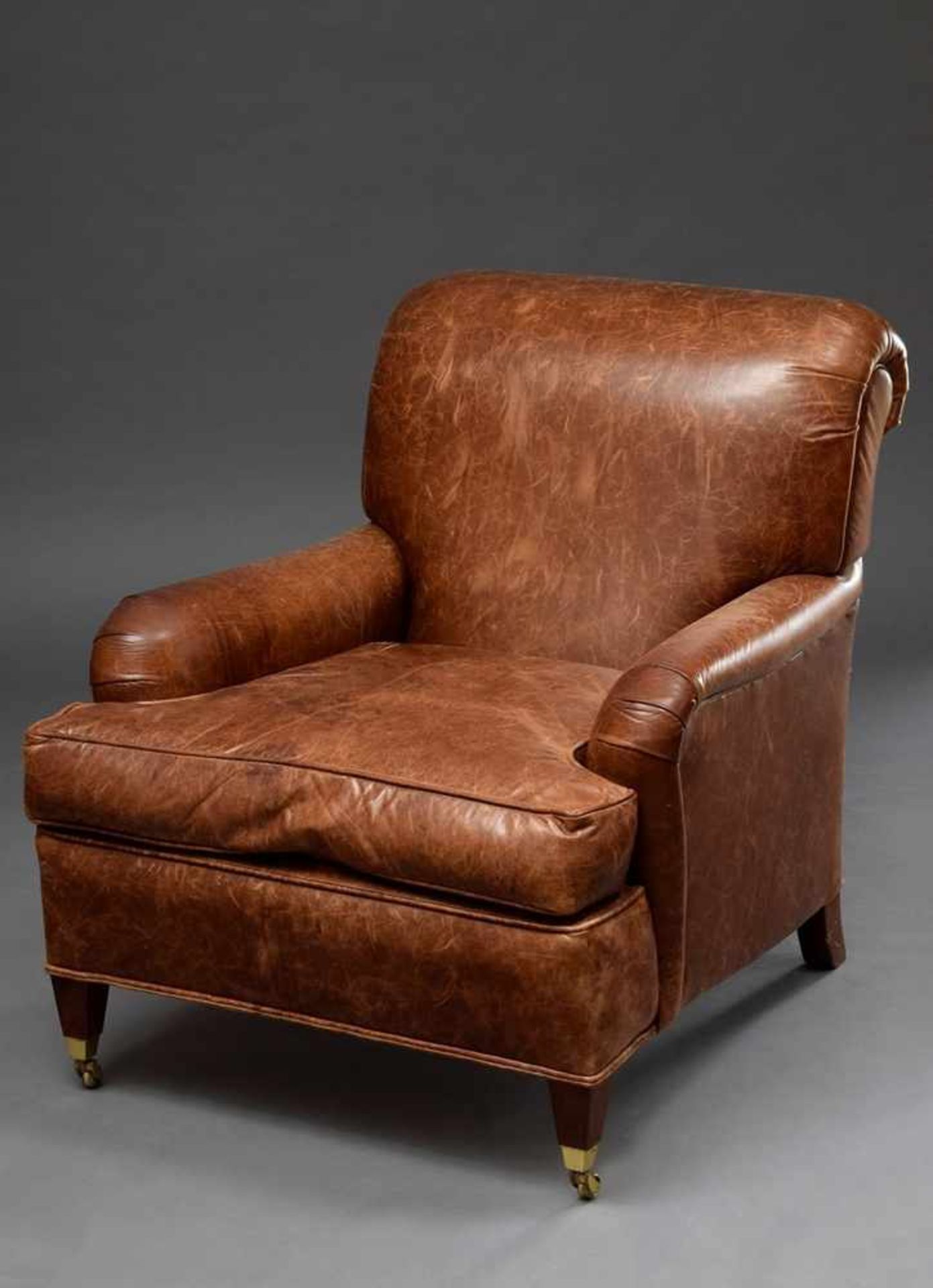 Brown leather armchair with volute handles in art deco style, h. 49/85cm, acquired by Hans Otto
