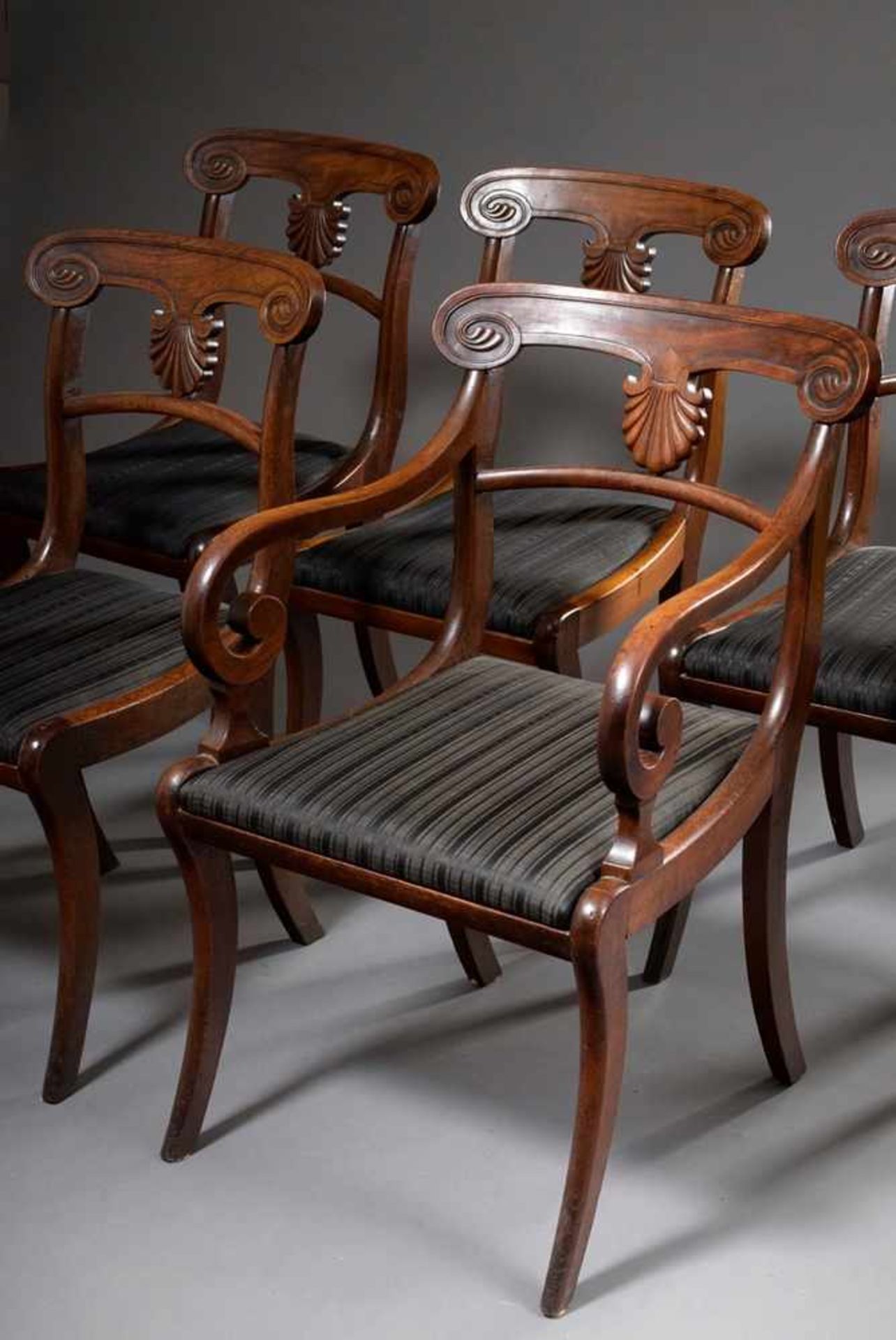 5 English Sheraton chairs with carved backrests and sabre legs, 1x with armrests, mahogany,