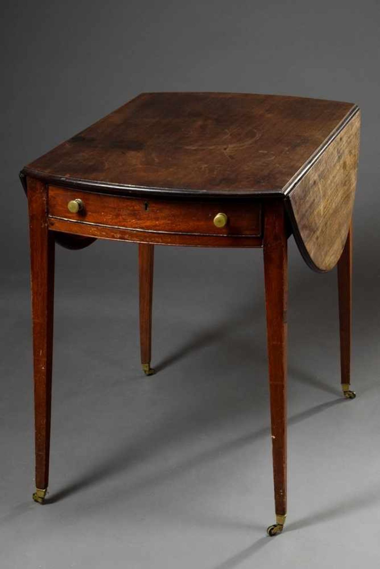 English mahogany pembroke table with semicircular side flaps and one drawer, on wheels, 19th