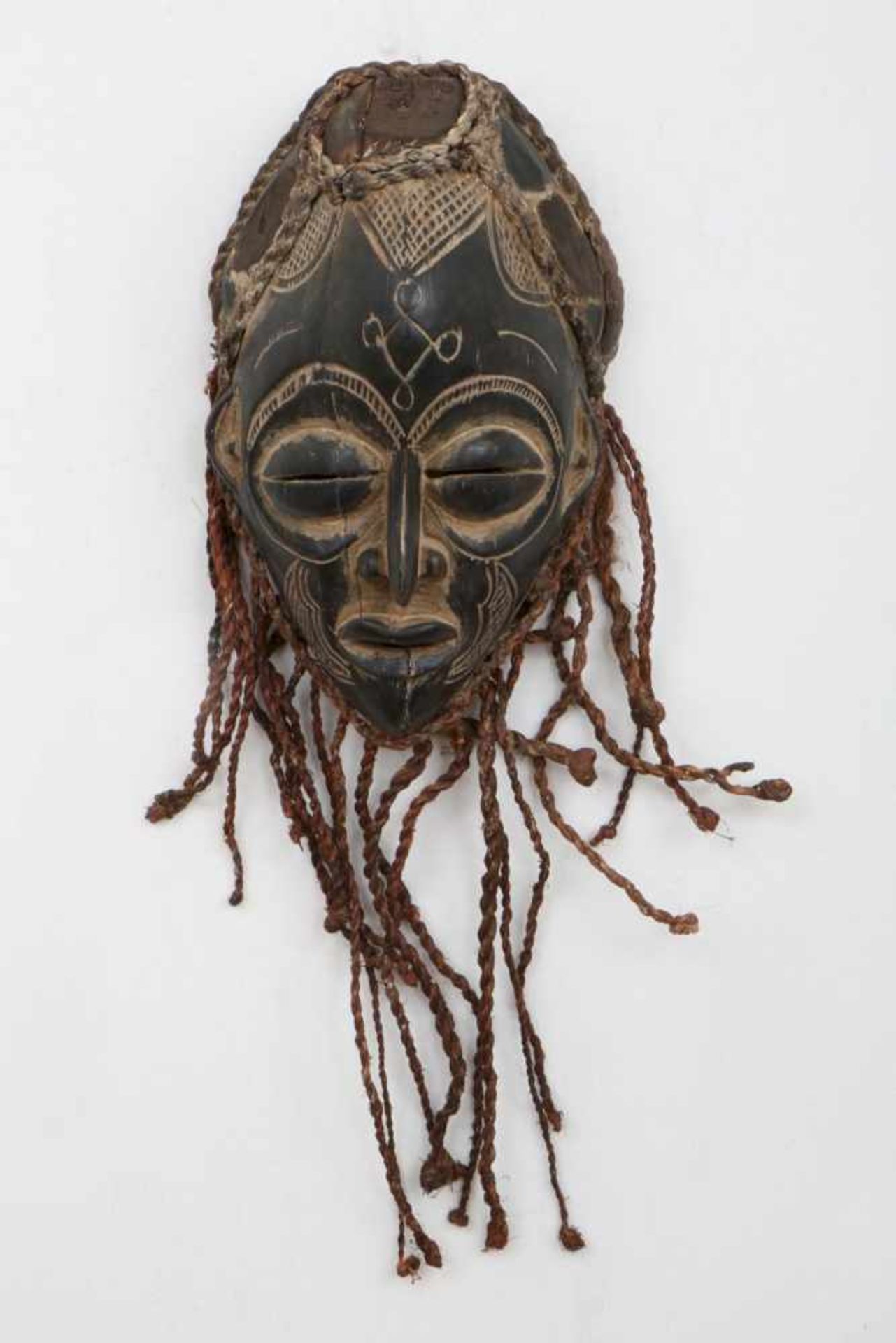 Afrikanische Tanzmaskewohl Kongo, Holz, geschnitzt und schwarz patiniert, Rafia Haar- und