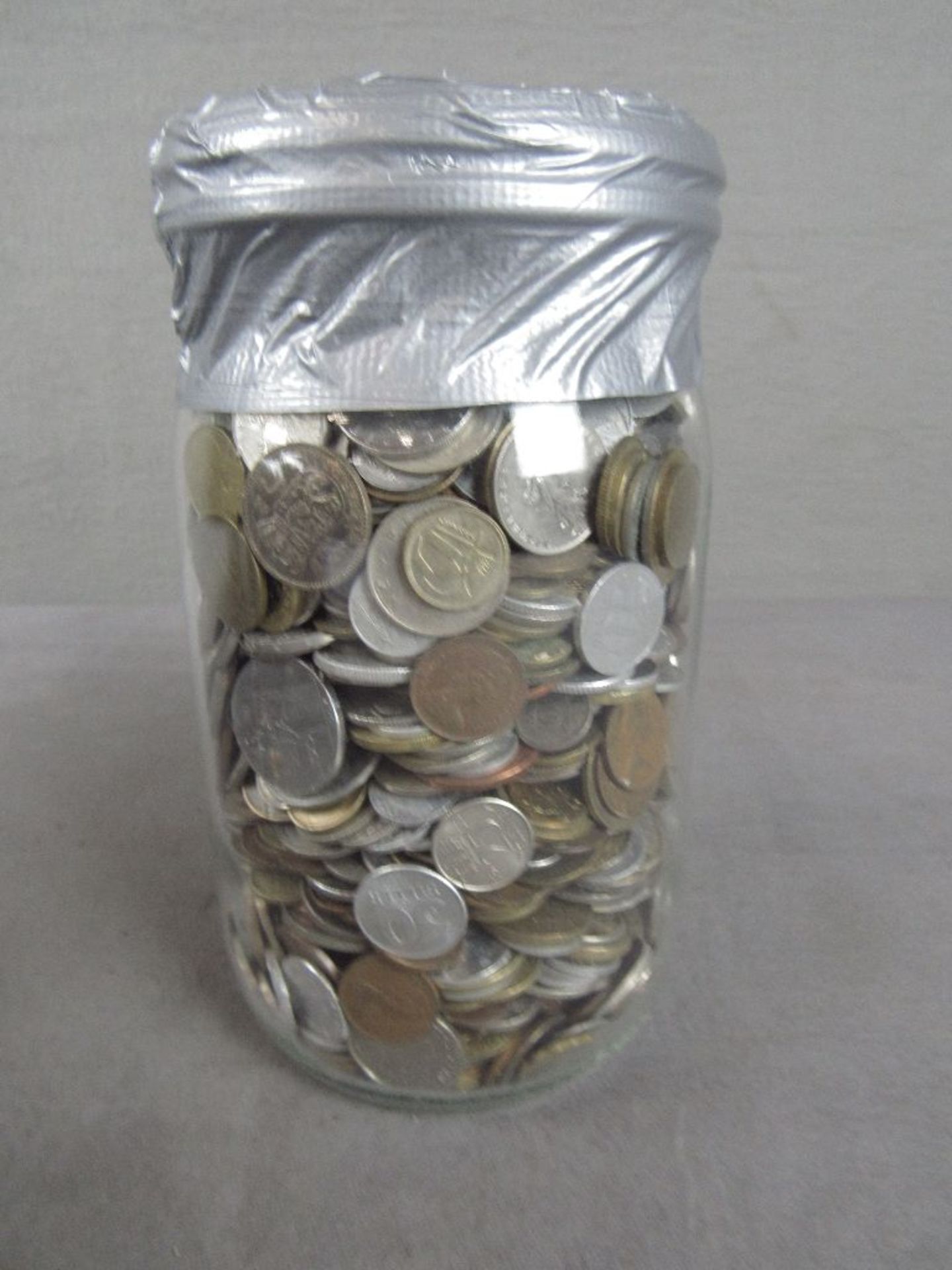 Prall gefülltes Glas mit Münzen