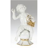 Porzellanfigur "Bacchus als Knabe auf Kugel sitzend", Fraureuth, weiß mit Goldstaffage, H.18 cm