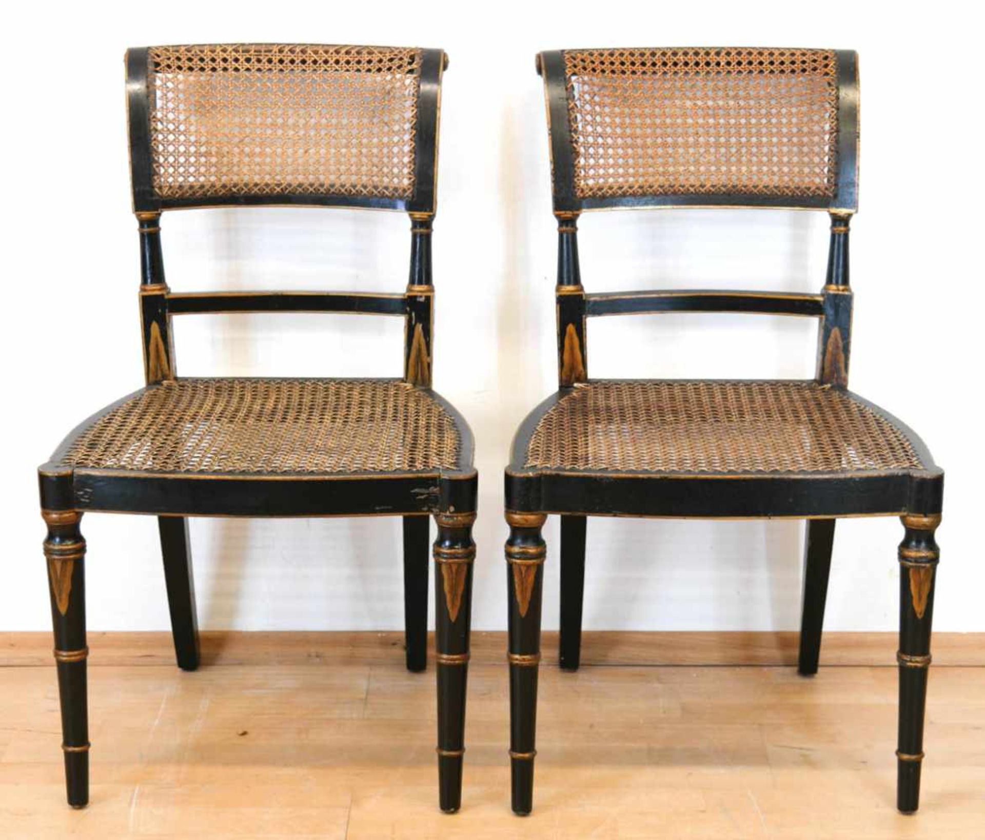 Paar Biedermeier-Stühle, ebonisiert mit Goldbemalung, Sitz und Rückenlehne mitRohrgeflecht, z.T.