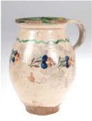 Henkelkrug, Schlesien 19. Jh., Bunzlauer Keramik, beige Glasur mit polychromerBlumenbemalung,
