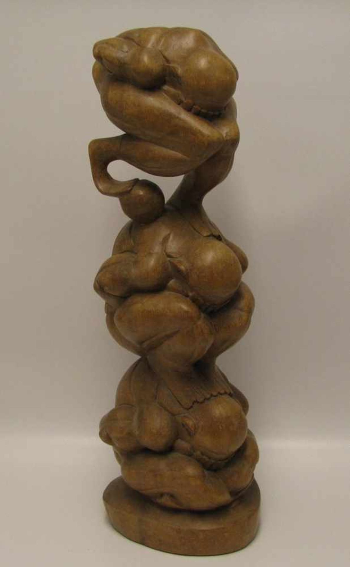 Drei Kauernde, Asien, Edelholz beschnitzt, h 51 cm, d 18 cm.