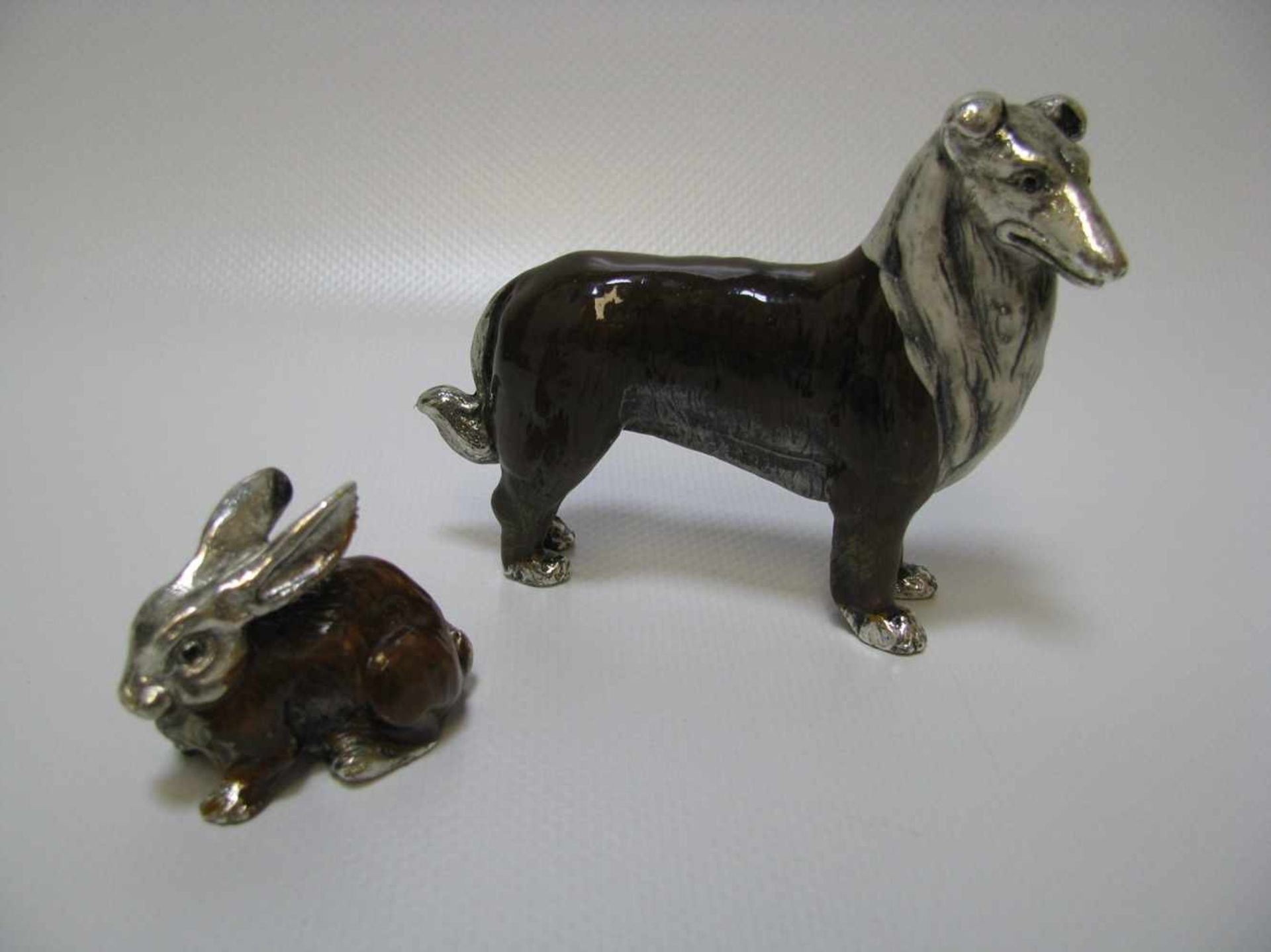 Collie und Hase, Metall mit polychromer Emailbemalung, h 7,5/3,5 cm.