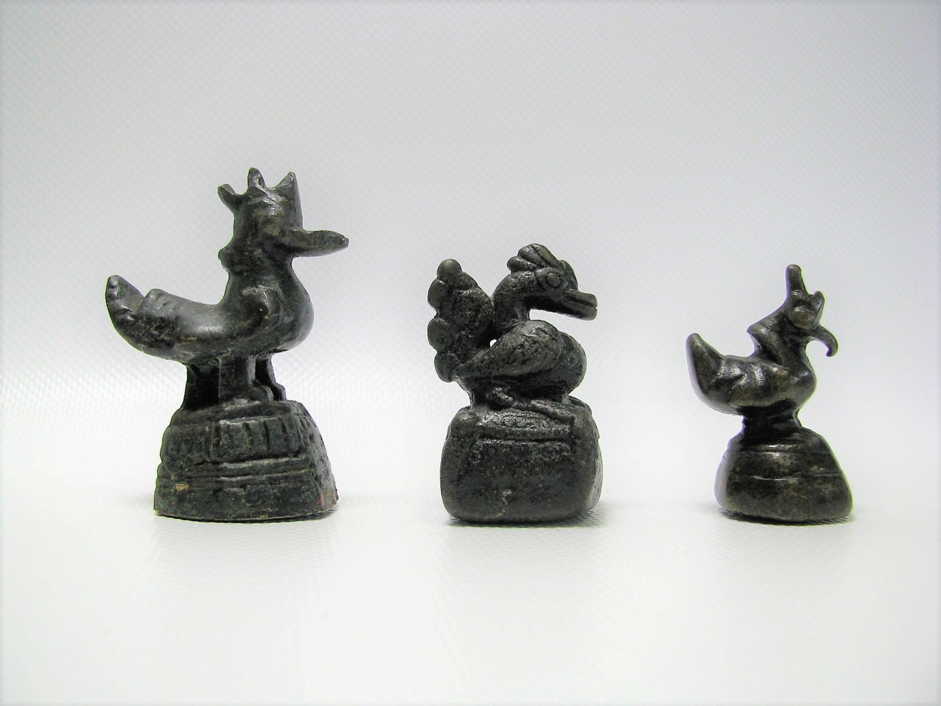 3 Opiumgewichte in Form von Hähnen, Burma, Bronze, h 4/4,5/5,5 cm.