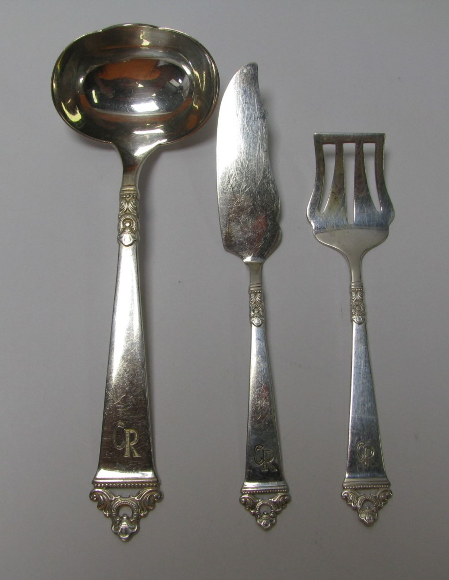 3 Vorleger, 830er Silber, gepunzt, 72 g, Monogramm "CR", längste l 16 cm.