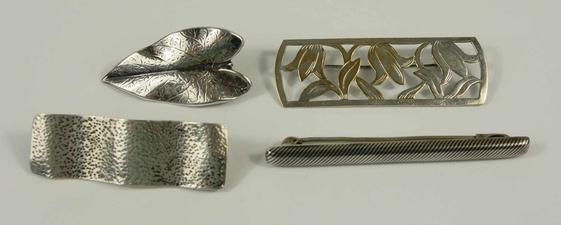 3 brooches and a dress clip, silver, weight 15,19g, different shapes, l. from 4cm to 6,3cm
