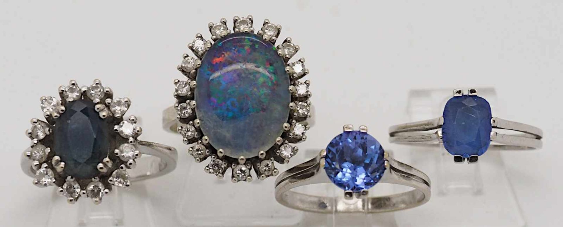 4 Damenringe WG 14ct., Brill., Opal, wohl Saphir u.a. z.T. Gsp.