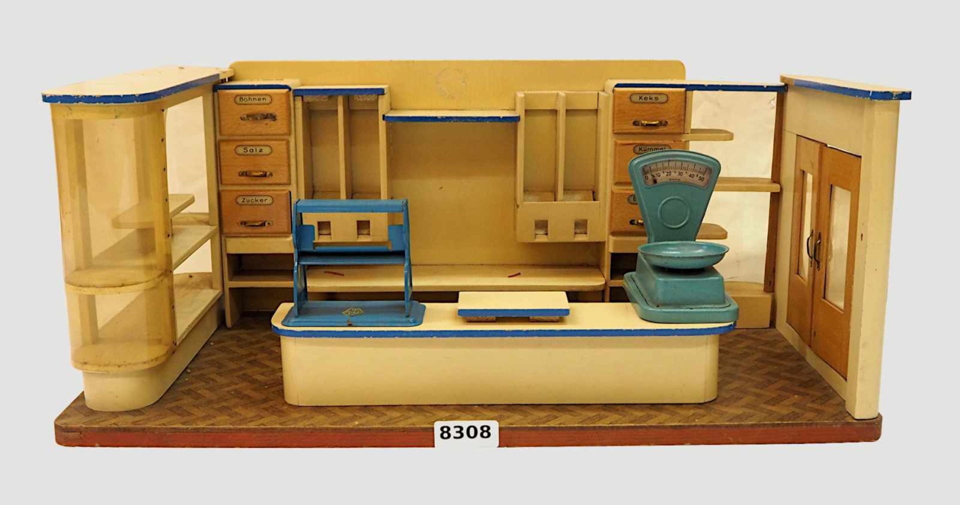 1 Puppenkaufladen wohl 1950er/1960er JahreH ca. 25cm B ca. 60cm z.T. besch. Asp.