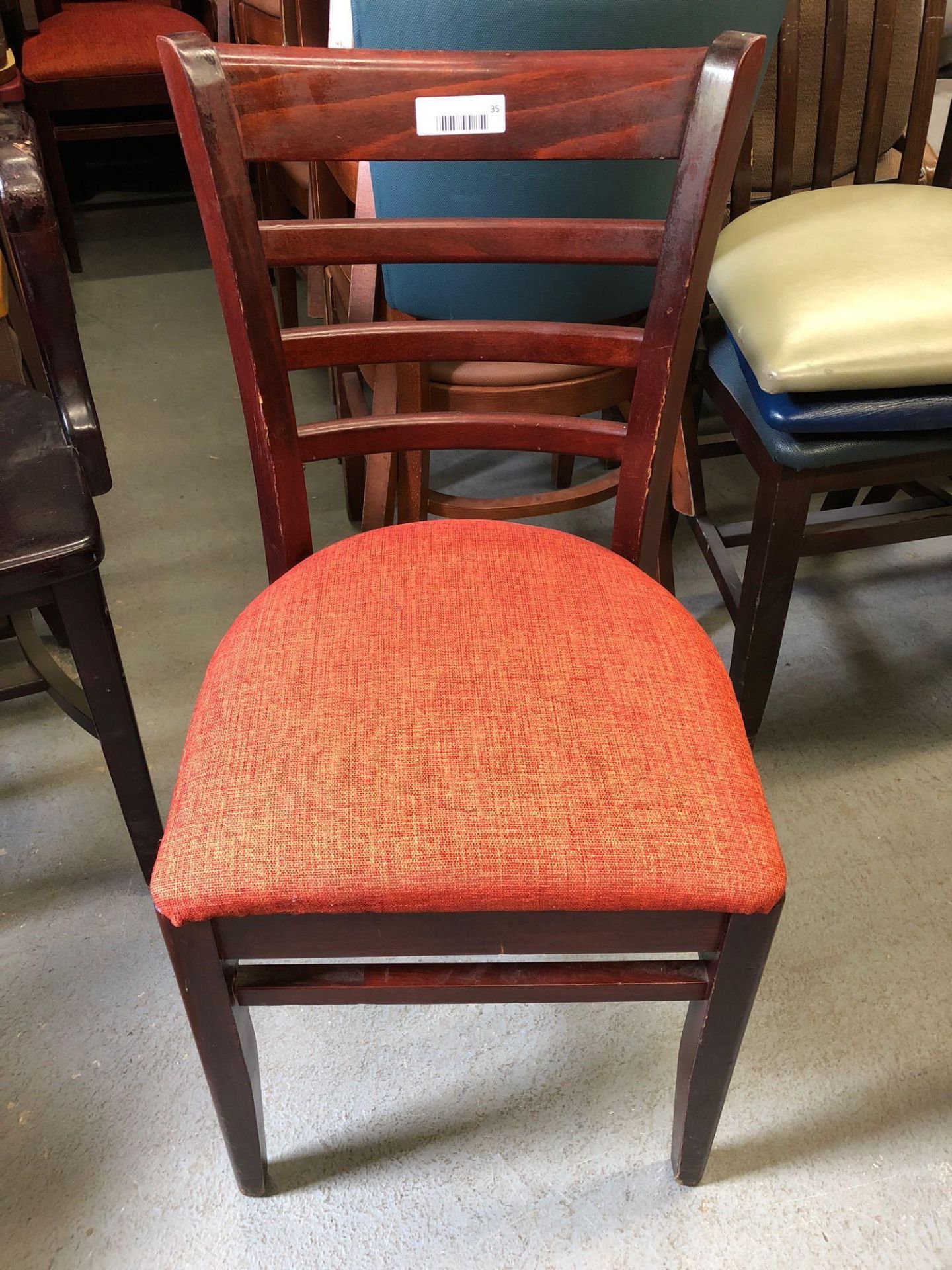 Mahogany ladder back chair with red fabric pad