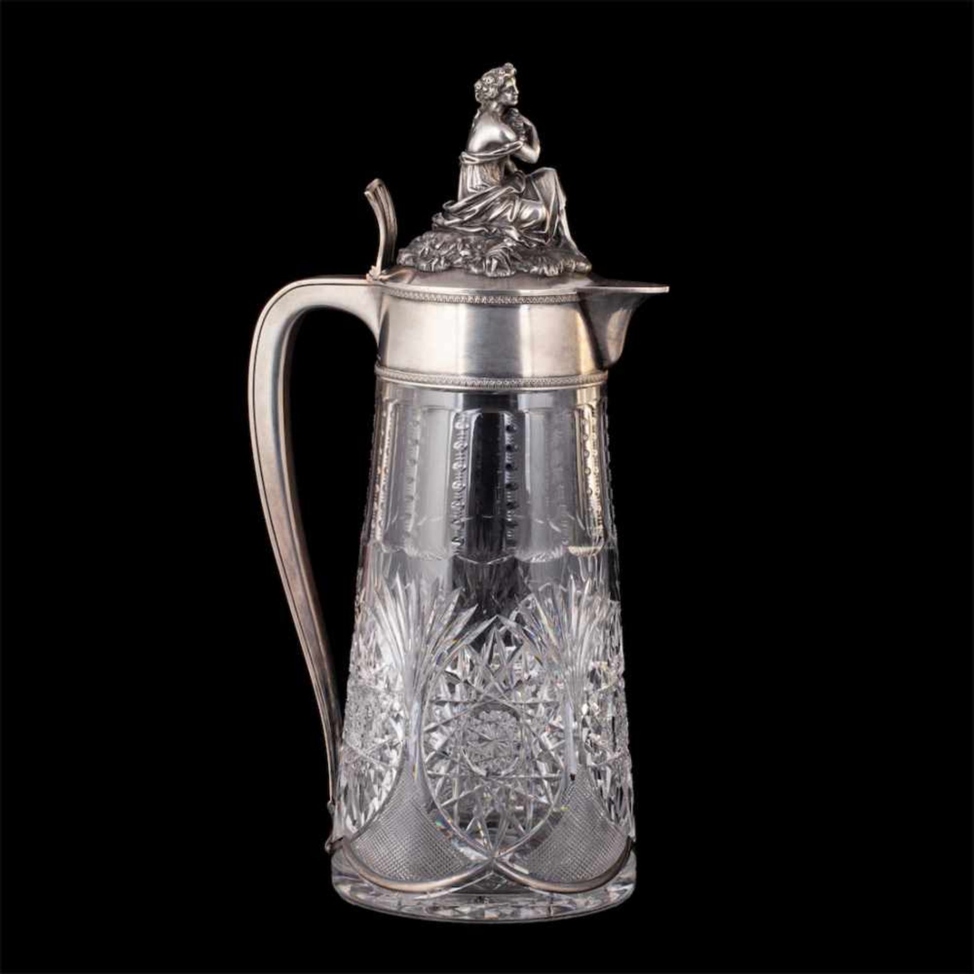 An unusual massive carafe with a cast figure