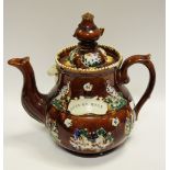 A 19th century Bargeware teapot, allover decorated with figures and flowers, surrounding a motto,