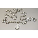 A 1920's Art Deco flapper girl clear glass bead necklace with droplet, silver coloured metal body,