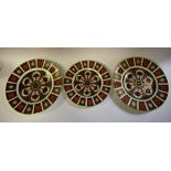 A pair of Royal Crown Derby 1128 pattern plates, 27cm diameter; another, 23cm,