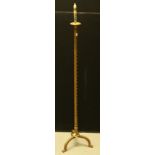 A 17th century style wrought iron floor standing tripod candlestick